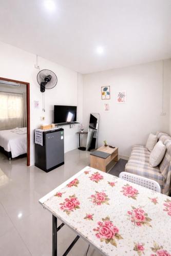 a living room with a couch and a table at Yada House s&h in Nai Yang Beach