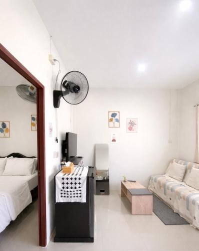 a white room with a bed and a couch at Yada House s&h in Nai Yang Beach