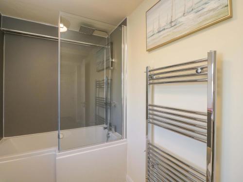 a shower in a bathroom with a glass door at 3 Woods Farm House in Chippenham