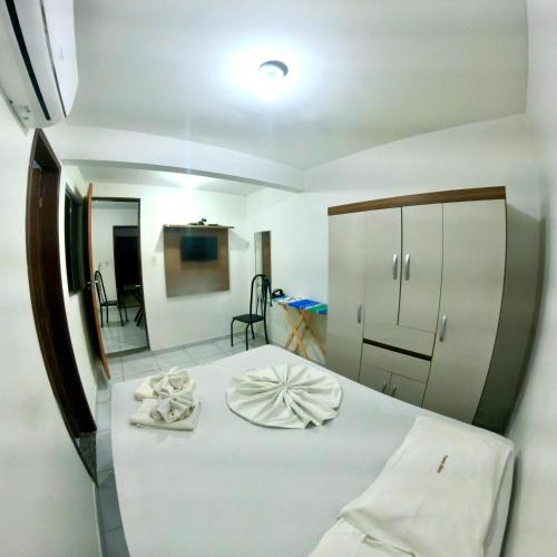 a bedroom with a bed with towels on it at Hotel Pousada Atlântica in João Pessoa