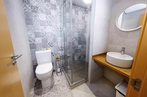 a bathroom with a shower and a toilet and a sink at Meeting Point Hostels in Barcelona