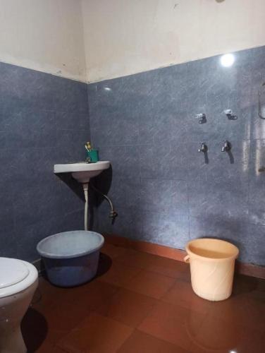 a bathroom with a toilet and a sink at Kasba Homes in Kalgha