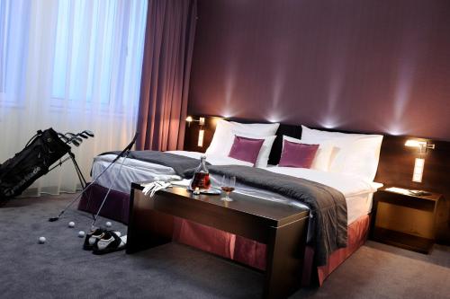 a bedroom with a bed and a desk with a camera at Hotel Turiec in Martin