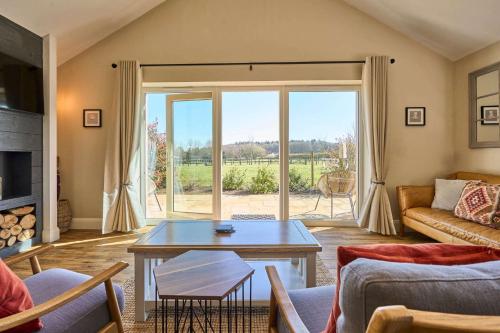 a living room with a couch and a table at Host & Stay - Mole Cottage in Swannington