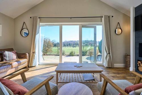 a living room with a couch and a table at Host & Stay - Toad Cottage in Swannington