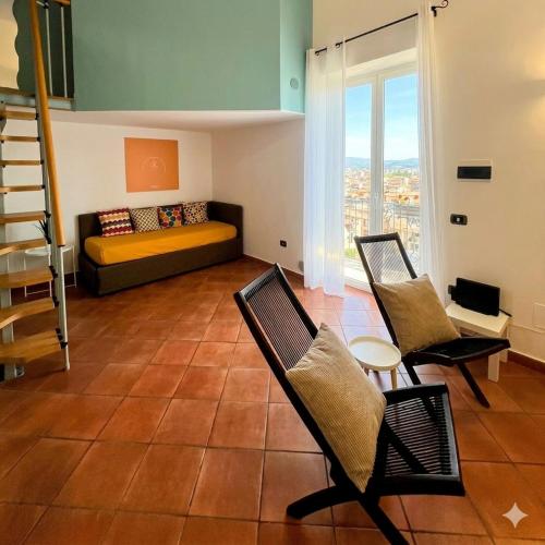 a living room with a couch and chairs in a room at Casa Nina-Bacoli Elegant & View in Bacoli
