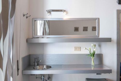 a bathroom with a sink and a mirror at Hotel Smart Cervia B&B in Cervia
