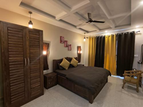 a bedroom with a bed and a ceiling fan at Nishtha Homestay in Lohaghāt