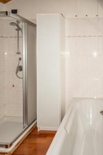 a bathroom with a tub and a shower at Liberty Apartment in Lovere