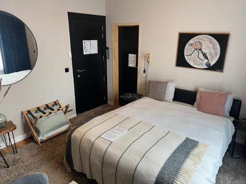 ein Schlafzimmer mit einem Bett und einem Spiegel in der Unterkunft Cozy Boutique hotel-Guesthouse Leuven -self check in in Löwen