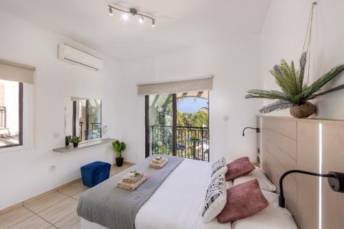 a bedroom with a large bed and a large window at Villa Mylos 7 in Protaras