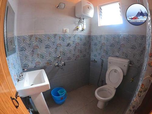 a bathroom with a toilet and a sink at Laskus Homestay in Darjeeling