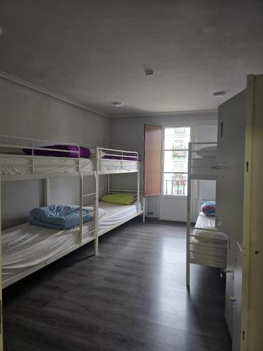 a room with three bunk beds in it at Hostel Catedral Burgos in Burgos