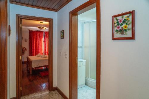 a hallway with a door to a room with a bathroom at Brisa de Sesimbra - Spacious Family Apartment, 5min Walk to the Beach with Private Parking in Sesimbra