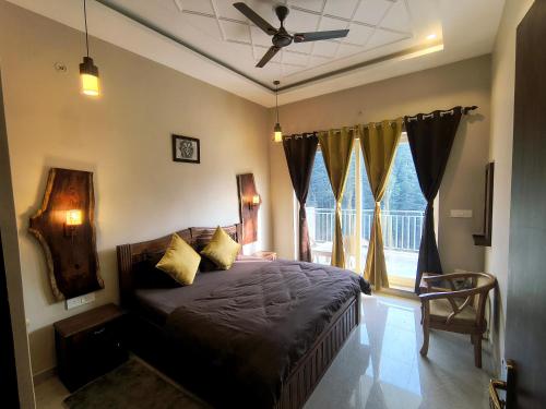 a bedroom with a bed and a ceiling fan at Nishtha Homestay in Lohaghāt