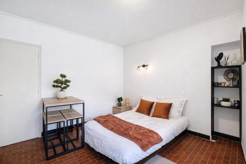 a bedroom with a bed and a side table at Le Nid d'andéol in Bourg-Saint-Andéol