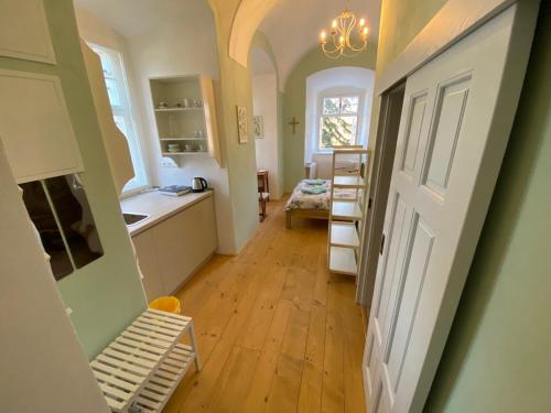 a room with a hallway with a kitchen and a door at Klášter Nová Říše in Nová Říše