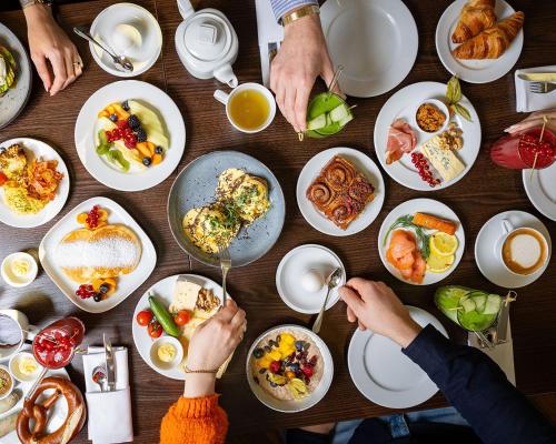 a group of people eating food on a table at Grand Hyatt Berlin in Berlin