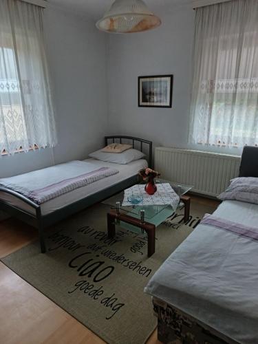 a living room with two beds and a table at Vila Josipa in Vukovar