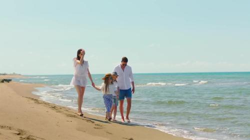 a family walking on the beach at Bursztynowy Horyzont Śliwin obok Rewal , Pobierowo in Śliwin