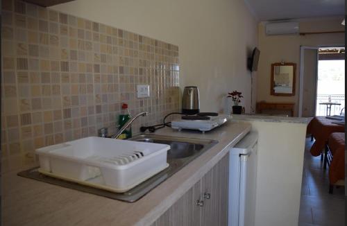 a kitchen with a sink with a slicer on it at Villa Miranda in Keri