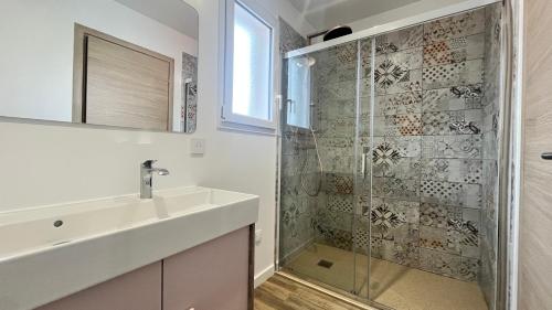 a bathroom with a sink and a shower at les jumelles villa 1 in Saint-Gaudens