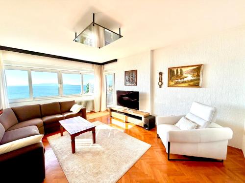 a living room with a couch and a table at Blue View Apartment in Opatija