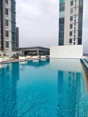 a swimming pool in the middle of two tall buildings at Bangi Studio Suite - Netflix in Kampong Sungai Ramal Dalam