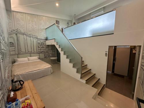a bedroom with a staircase and a bed in it at Lan Yang Resort Four Seasons in Dongshan