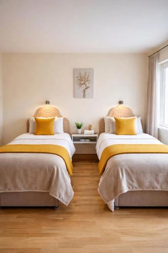 two beds sitting next to each other in a bedroom at Jordan's Drum Haven B&B, Knock in Knock
