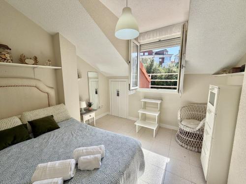 a bedroom with a bed and a large window at Apartamento Somo 30608 in Somo