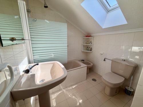 a bathroom with a sink and a toilet and a bath tub at Apartamento Somo 30608 in Somo