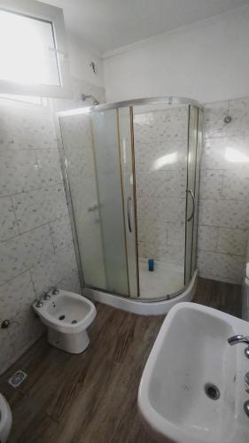 a bathroom with a shower and a toilet and a sink at rocky in Concordia