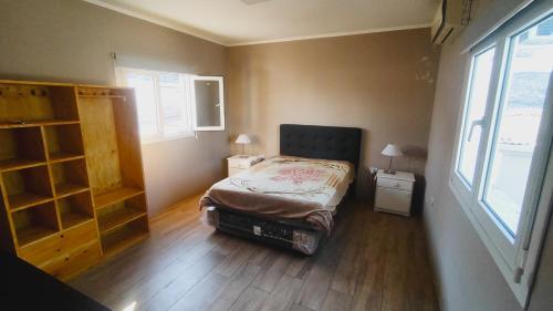 a small bedroom with a bed and a window at rocky in Concordia