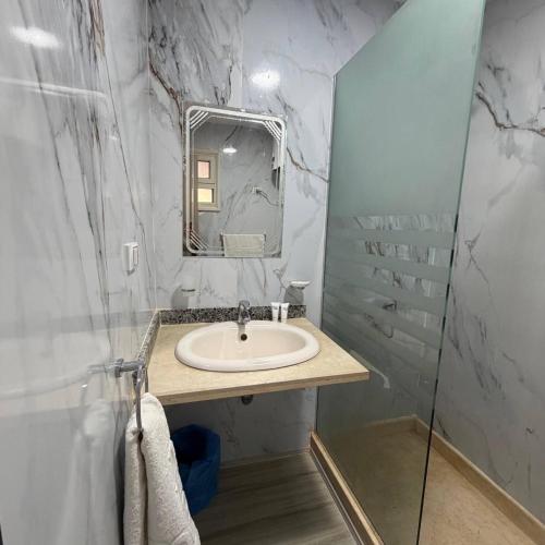 a bathroom with a sink and a mirror at Porto View in Hurghada