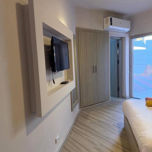 a hotel room with a television and a bed at Porto View in Hurghada