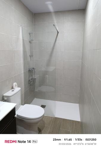 a bathroom with a shower and a toilet and a sink at La ERA in Aldeadávila de la Ribera