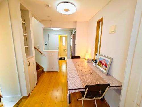a room with a table with a picture on it at Limited Golden Week Deal , Ueno 10minutes, Tokyo University 10minutes, three BR, three toilets, Max 10 people Free parking in Tokyo