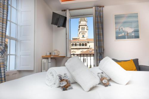 a bedroom with a bed with a view of a building at Casa Celsa-Barbantes in Santiago de Compostela