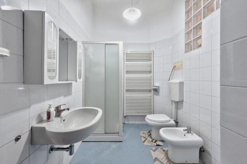 a white bathroom with a sink and a toilet at Apt Venice City in Mestre