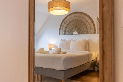 a bedroom with a bed and a mirror at Le Grenier cocoon in Romorantin