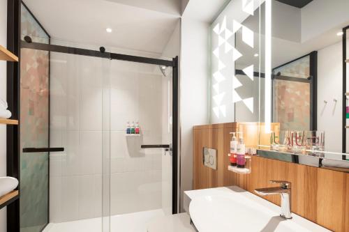 a bathroom with a shower and a sink at Alt Hotel Ottawa Airport in Ottawa