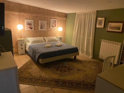 a bedroom with a bed with two towels on it at Relais Le Folaghe in Ladispoli