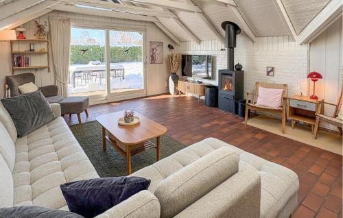 a living room with a couch and a table at Amazing Home In Odder With Sauna in Odder