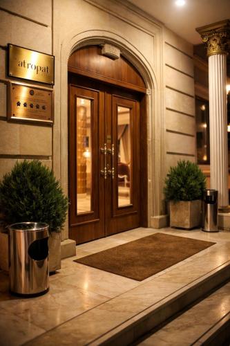 a front door of a building with two potted plants at Atropat Old City Hotel in Baku