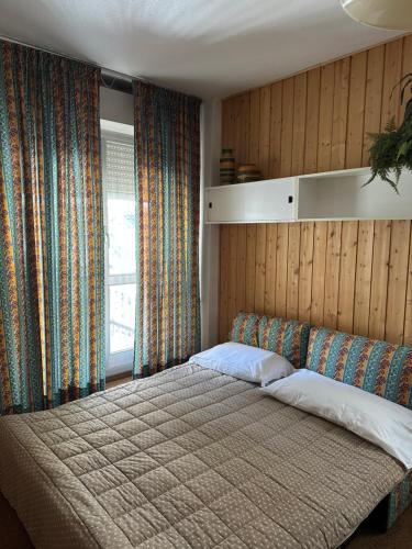 a bedroom with a large bed in front of a window at Il rifugio di Pietro in Sella della Turra