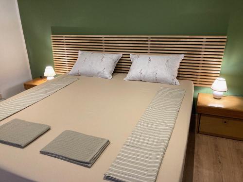 a bedroom with a large bed with two pillows at Casa Dante in Gradisca dʼIsonzo