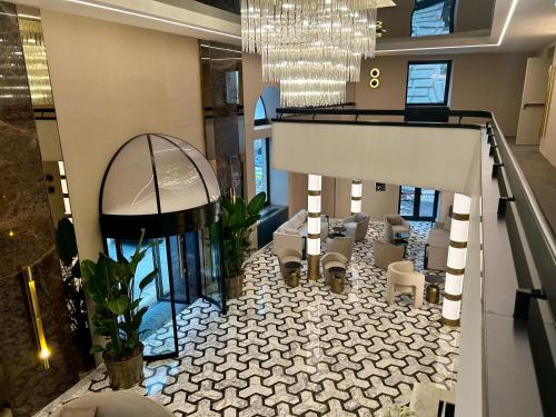 a lobby with a table and chairs in a building at Aria Palace by OMNIA hotels in Rome