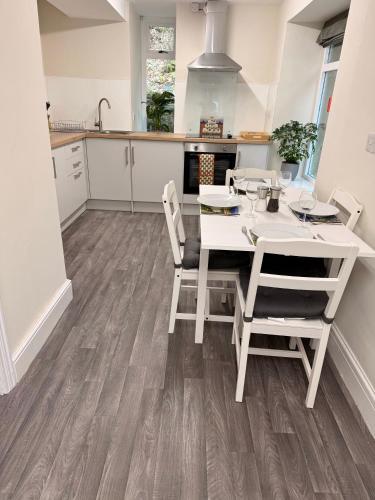 a kitchen and dining room with a table and chairs at 1 Bron Rhedyn Holiday Cottage in Betws-y-coed