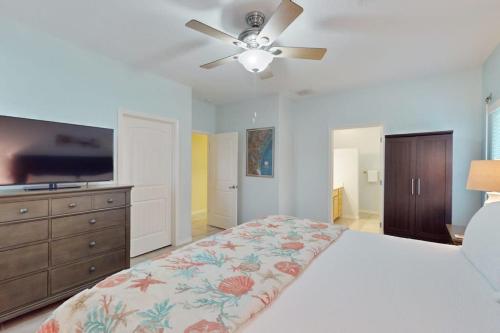 a bedroom with a bed and a ceiling fan at Take Me To The Beach in Rockport